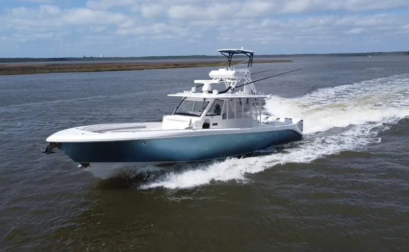 Slide: The Image of 2016 Everglades 435 Center Console boat cruising on open water. - 4