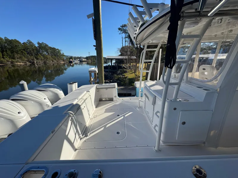 Slide: The Image of 2016 Everglades 435 Center Console boat docked by a serene river. - 43