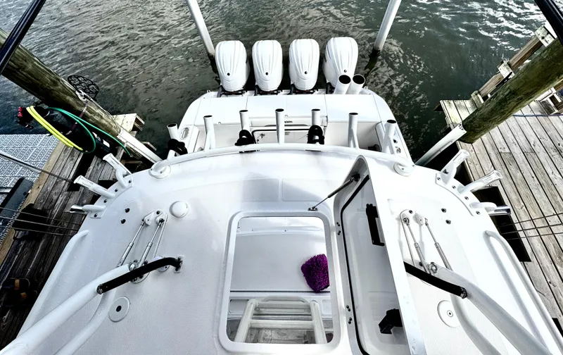 Slide: The Image of 2016 Everglades 435 Center Console boat with four engines docked at a marina. - 44