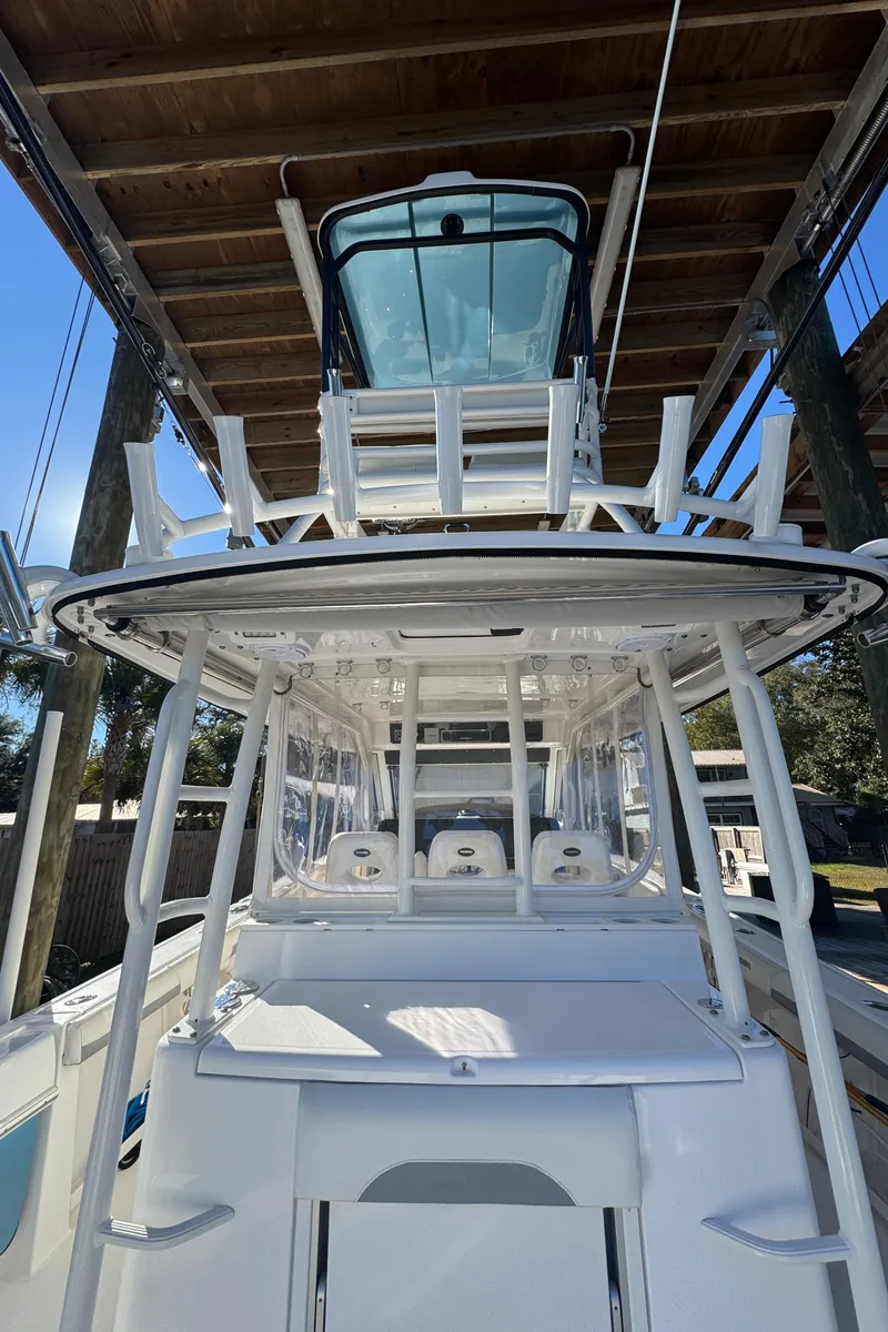 Slide: The Image of 2016 Everglades 435 Center Console boat under a wooden dock. - 48