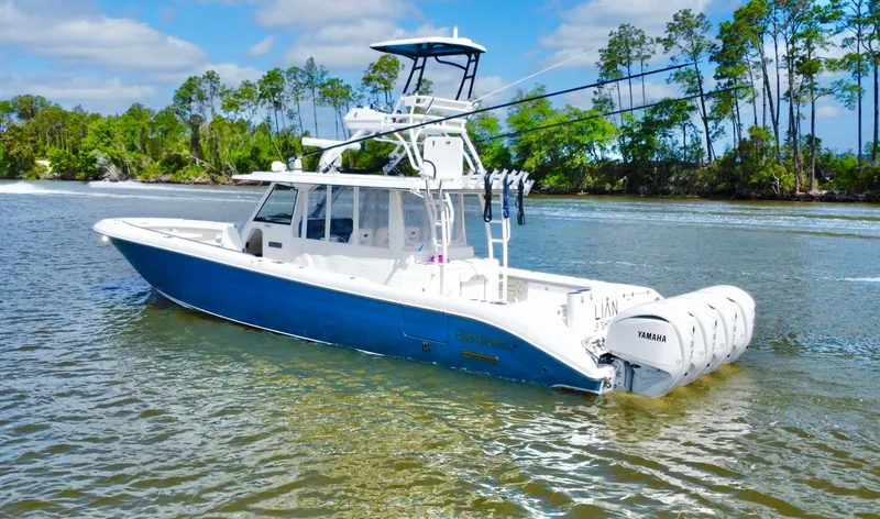 Slide: The Image of 2016 Everglades 435 Center Console boat on water, featuring blue hull and multiple outboard engines. - 7