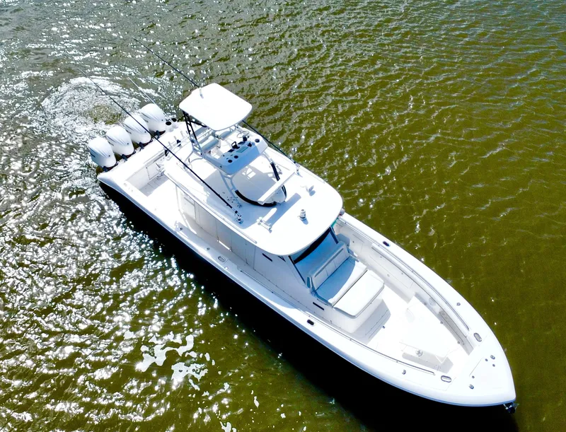 Slide: The Image of 2016 Everglades 435 Center Console boat cruising on water, aerial view. - 8