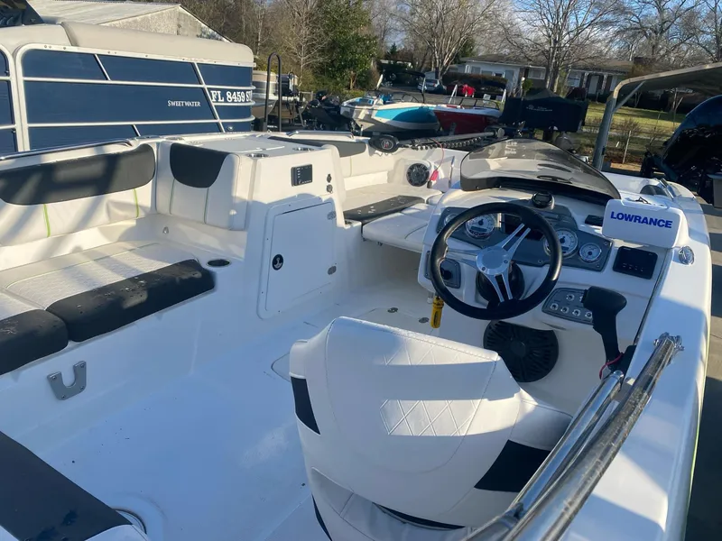 Slide: The Image of 2022 Tahoe 2150 boat interior with steering wheel and seating, featuring Lowrance equipment. - 6