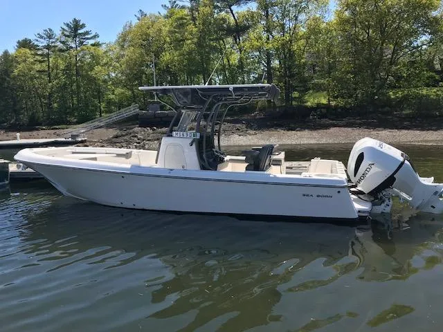Slide: The Image of 2025 Sea Born LX26 Center Console boat docked on calm water. - 15