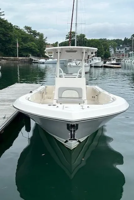Slide: The Image of 2025 Sea Born LX26 Center Console boat docked in a serene marina. - 4
