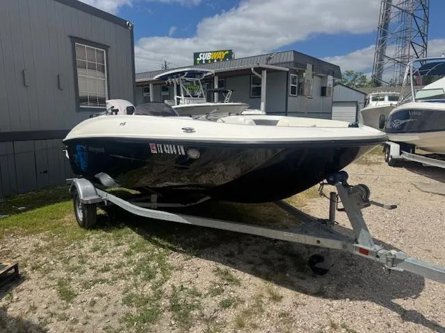 Slide: The Image of 2019 Bayliner Element E16 boat on trailer, parked outdoors near buildings. - 0