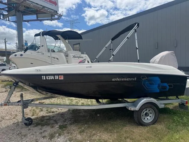 Slide: The Image of 2019 Bayliner Element E16 boat on trailer, parked outdoors under a cloudy sky. - 3