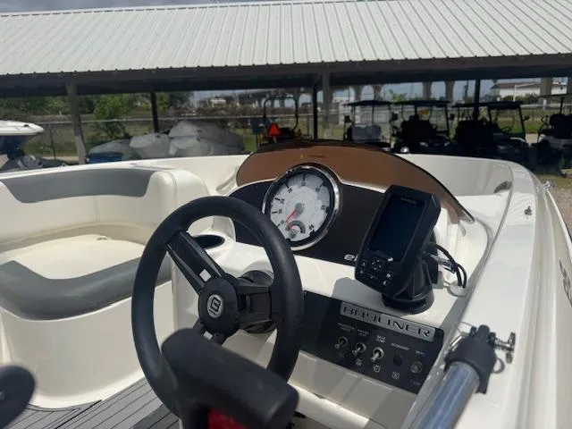 Slide: The Image of 2019 Bayliner Element E16 boat dashboard with steering wheel and gauges. - 5