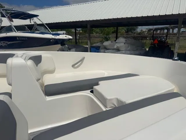 Slide: The Image of 2019 Bayliner Element E16 boat interior with white seating under a covered area. - 9