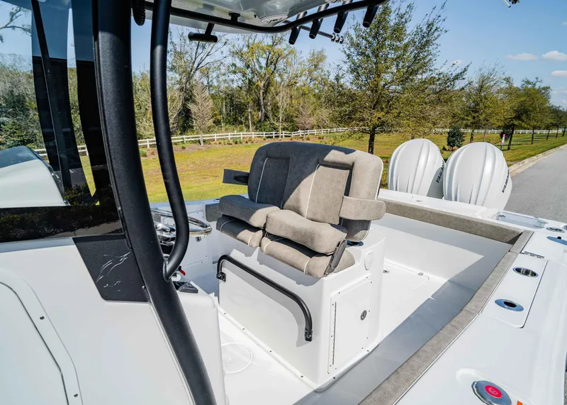 Slide: The Image of 2025 Sea Hunt Gamefish 27 FS boat interior with dual seats and twin engines. - 13