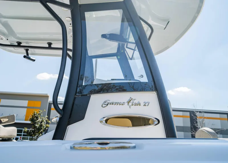 Slide: The Image of 2025 Sea Hunt Gamefish 27 FS boat console with clear sky background. - 18