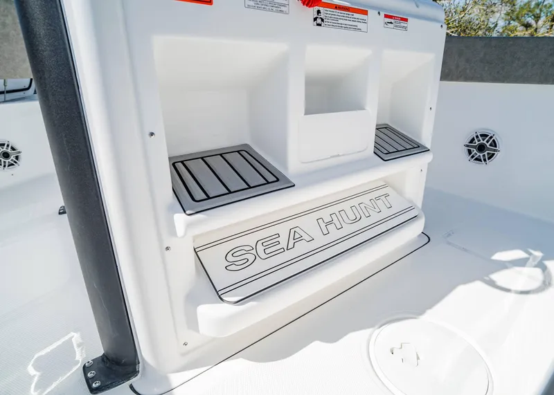 Slide: The Image of 2025 Sea Hunt Gamefish 27 FS boat interior with branded step and storage compartments. - 19