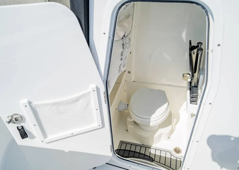 Slide: The Image of 2025 Sea Hunt Gamefish 27 FS boat interior with compact marine toilet. - 20