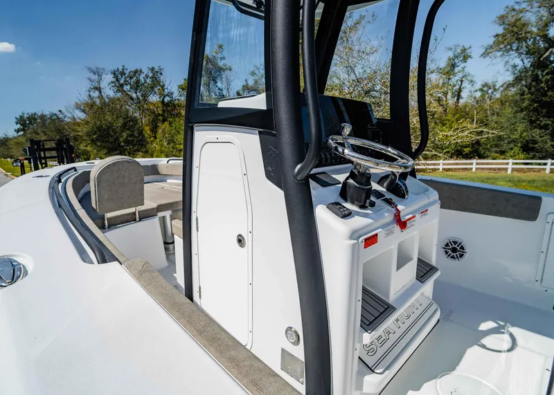 Slide: The Image of 2025 Sea Hunt Gamefish 27 FS boat interior with steering console and seating. - 21