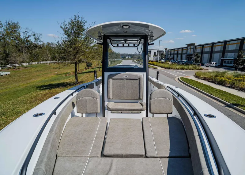 Slide: The Image of 2025 Sea Hunt Gamefish 27 FS boat interior with cushioned seating and open deck. - 24
