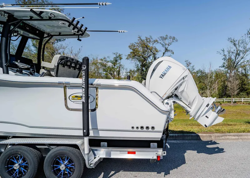 Slide: The Image of 2025 Sea Hunt Gamefish 27 FS boat with Yamaha outboard motor on a trailer. - 3