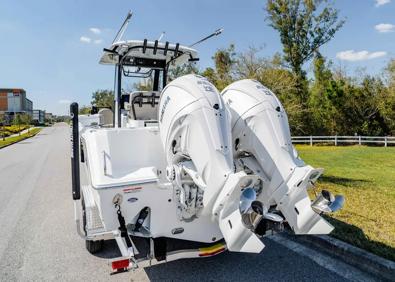 Slide: The Image of 2025 Sea Hunt Gamefish 27 FS with dual Yamaha outboard motors on a sunny street. - 5