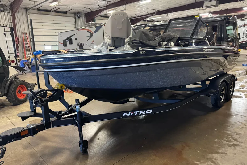 Slide: The Image of 2024 Nitro ZV19 Sport boat on trailer in indoor garage setting. - 1