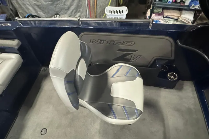 Slide: The Image of 2024 Nitro ZV19 Sport boat interior with cushioned seating and logo detail. - 11