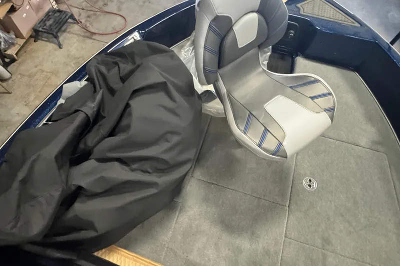 Slide: The Image of 2024 Nitro ZV19 Sport boat interior with gray seat and black cover. - 12