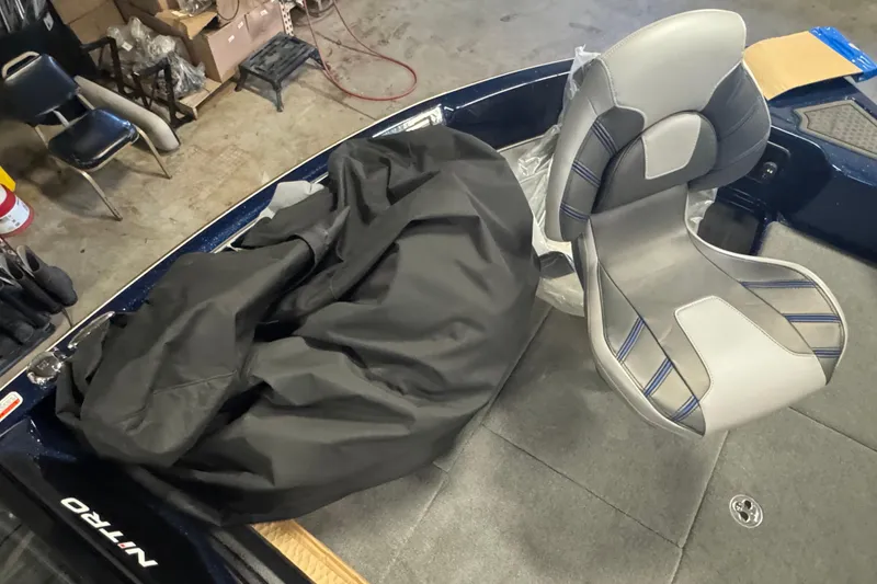 Slide: The Image of 2024 Nitro ZV19 Sport boat interior with gray seat and black cover. - 13