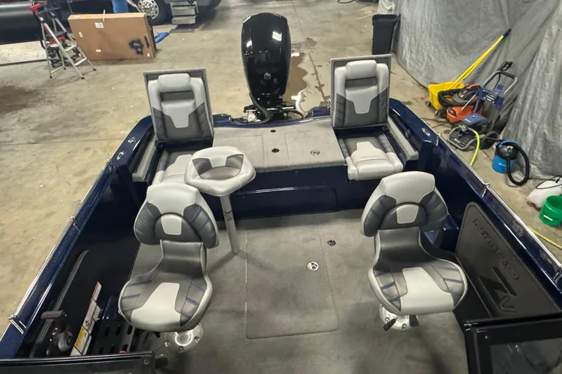 Slide: The Image of 2024 Nitro ZV19 Sport boat interior with four gray seats in a garage setting. - 14