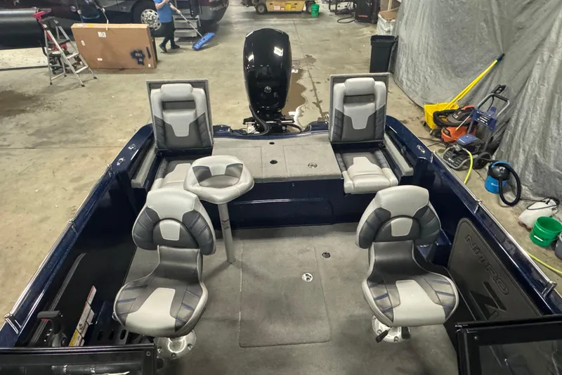 Slide: The Image of 2024 Nitro ZV19 Sport boat interior with gray seating in a garage setting. - 15