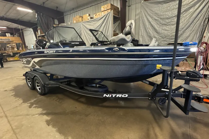 Slide: The Image of 2024 Nitro ZV19 Sport boat in a warehouse, on a trailer, side view. - 2
