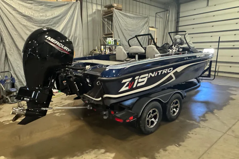 Slide: The Image of 2024 Nitro ZV19 Sport boat with Mercury engine in a garage setting. - 4