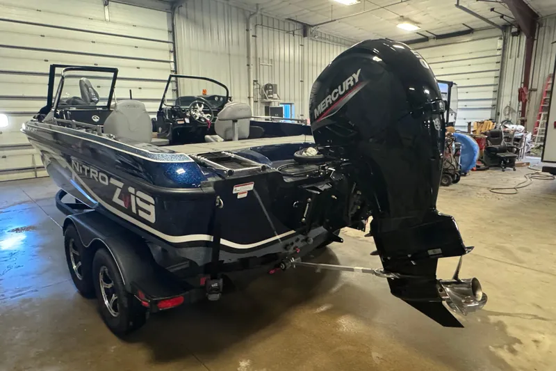Slide: The Image of 2024 Nitro ZV19 Sport boat with Mercury engine in a garage setting. - 5