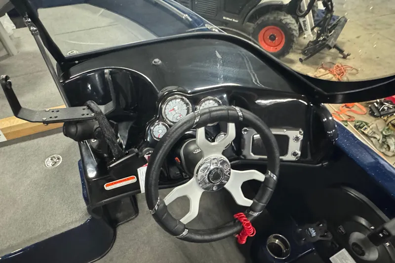 Slide: The Image of 2024 Nitro ZV19 Sport boat dashboard with steering wheel and gauges. - 9