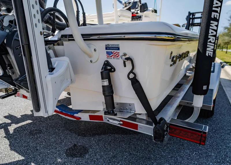 Slide: The Image of 2024 Spyder FX 19 Vapor boat on trailer, rear view showing branding and equipment. - 13