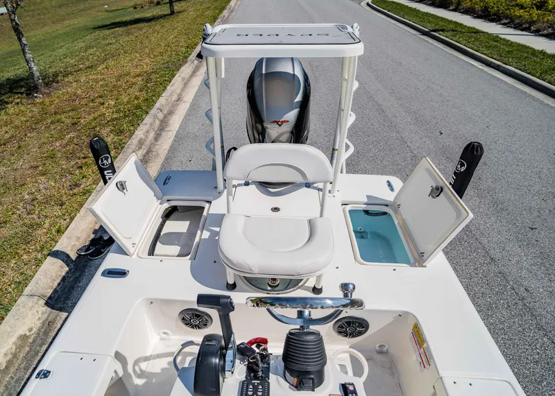 Slide: The Image of 2024 Spyder FX 19 Vapor boat interior with open storage compartments and seating. - 14