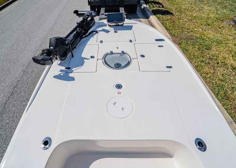 Slide: The Image of 2024 Spyder FX 19 Vapor boat deck with storage compartments and trolling motor. - 16