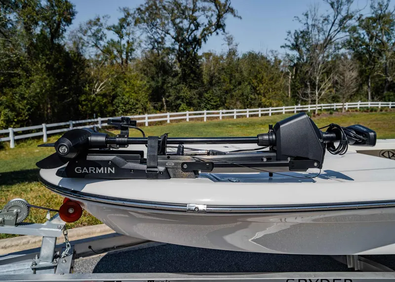 Slide: The Image of 2024 Spyder FX 19 Vapor boat with Garmin trolling motor, parked outdoors. - 17
