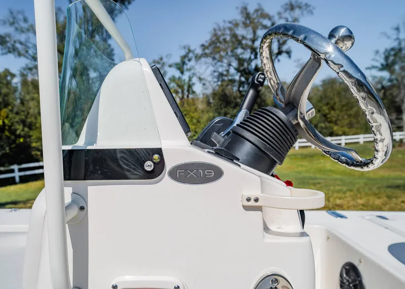 Slide: The Image of 2024 Spyder FX 19 Vapor boat console with steering wheel, outdoors. - 6
