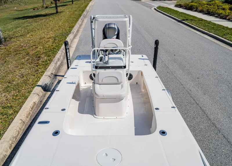 Slide: The Image of 2024 Spyder FX 19 Vapor boat on a road, showcasing deck and seating. - 7