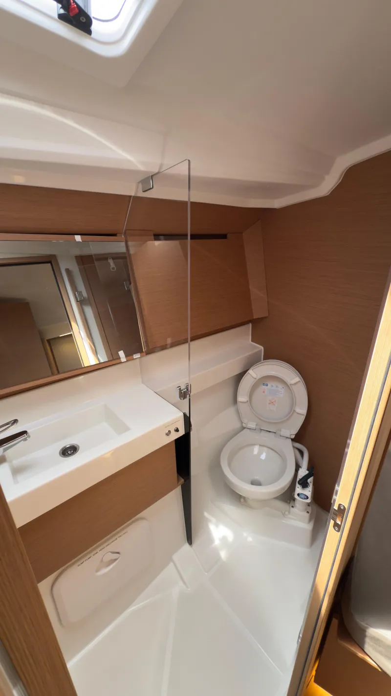 Slide: The Image of Modern bathroom in 2022 Jeanneau Sun Odyssey 410 yacht, featuring sleek design and compact amenities. - 11