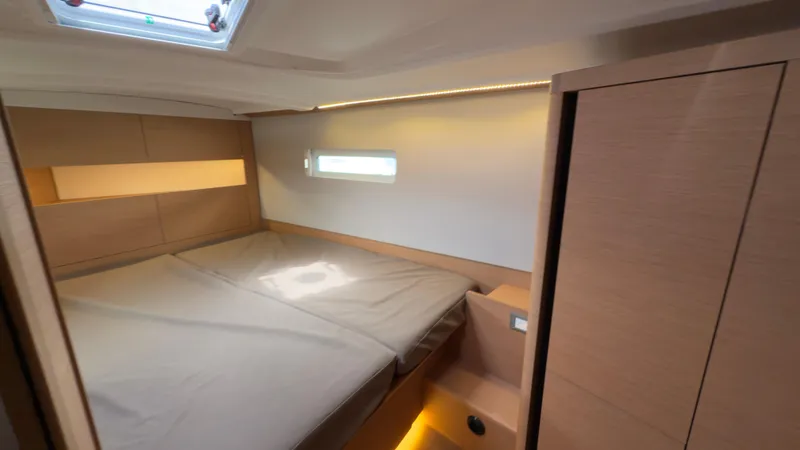 Slide: The Image of Cozy cabin interior of 2022 Jeanneau Sun Odyssey 410 sailboat with modern design. - 12
