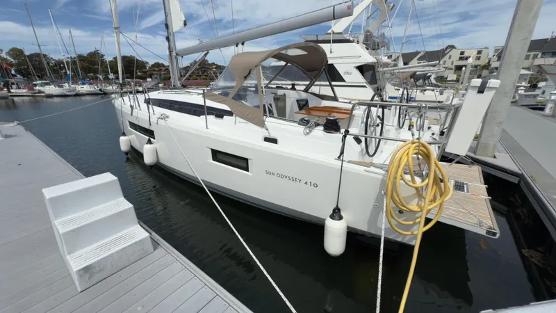 Slide: The Image of 2022 Jeanneau Sun Odyssey 410 sailboat docked at marina, side view. - 2