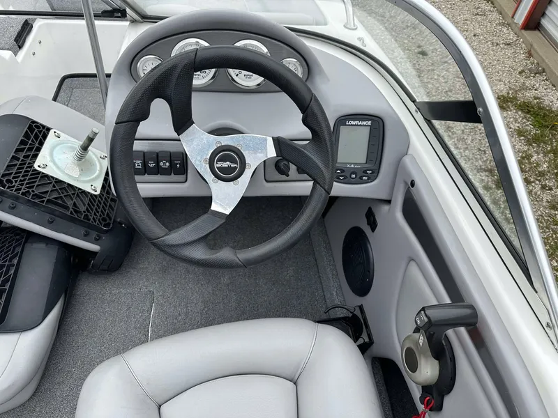 Slide: The Image of 2009 Skeeter SL 190 boat dashboard with steering wheel and control panel. - 10