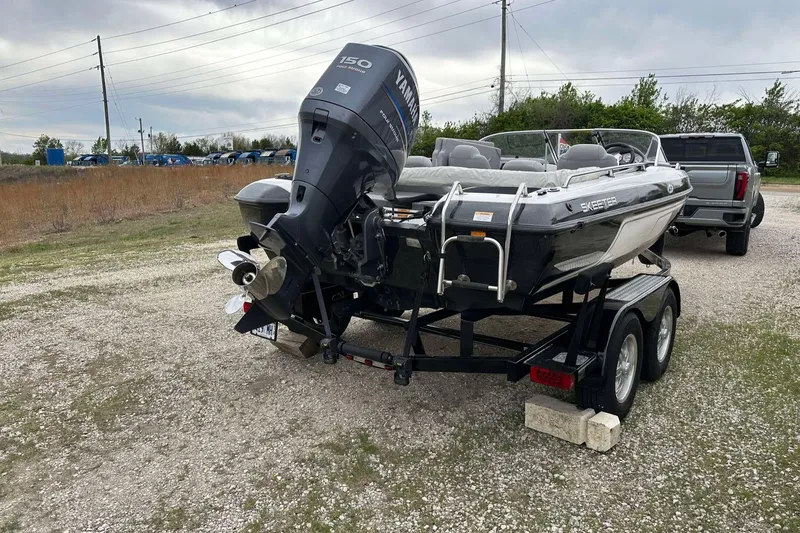 Slide: The Image of 2009 Skeeter SL 190 boat on trailer with Yamaha outboard motor in outdoor setting. - 13