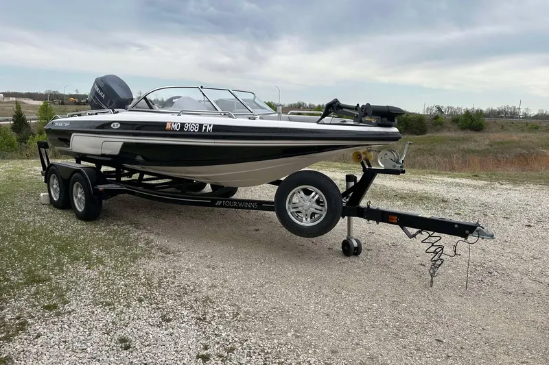 Slide: The Image of 2009 Skeeter SL 190 boat on trailer, parked on gravel, under cloudy sky. - 16