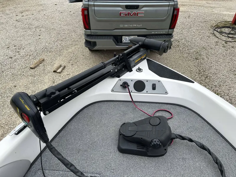 Slide: The Image of 2009 Skeeter SL 190 boat with trolling motor, parked near a GMC Denali truck. - 18