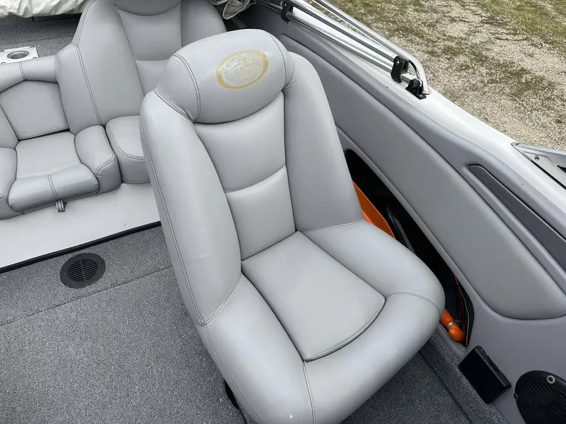 Slide: The Image of 2009 Skeeter SL 190 boat interior with gray seating and carpeted flooring. - 25