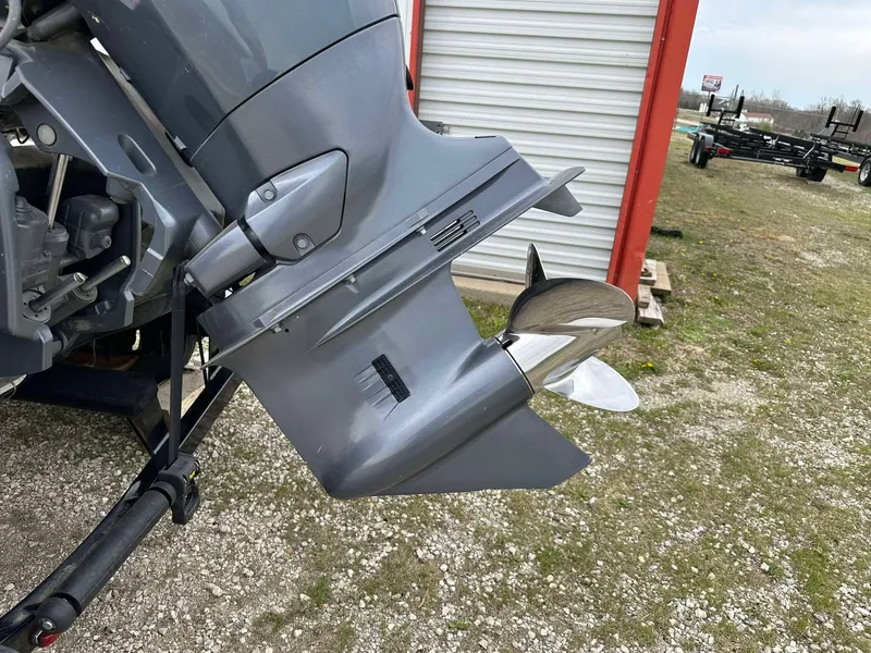 Slide: The Image of 2009 Skeeter SL 190 boat motor and propeller, parked on gravel near a storage unit. - 3
