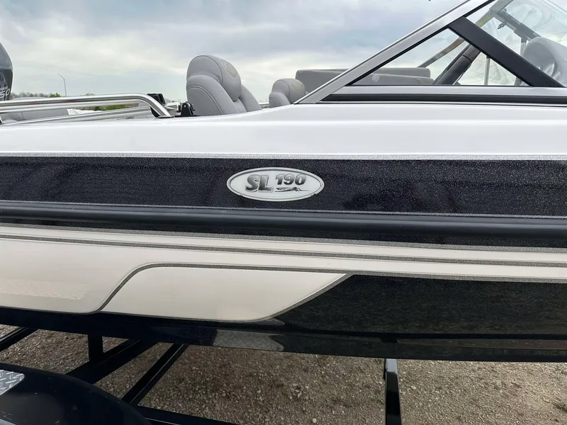 Slide: The Image of 2009 Skeeter SL 190 boat side view with logo, featuring sleek design and comfortable seating. - 36