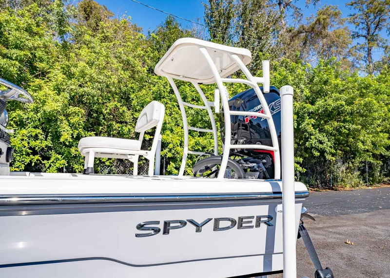 Slide: The Image of 2024 Spyder FX 19 Vapor boat with seating and motor, surrounded by lush greenery. - 11