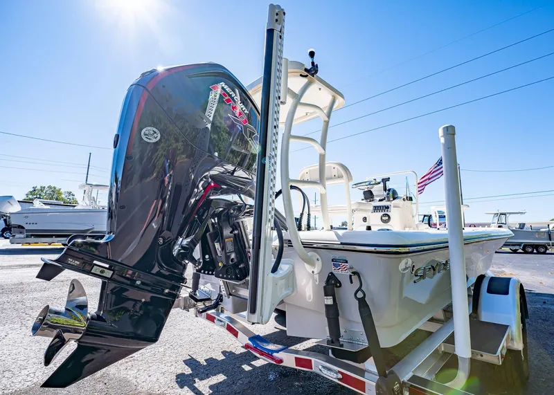 Slide: The Image of 2024 Spyder FX 19 Vapor boat with powerful outboard motor, parked on a trailer. - 15