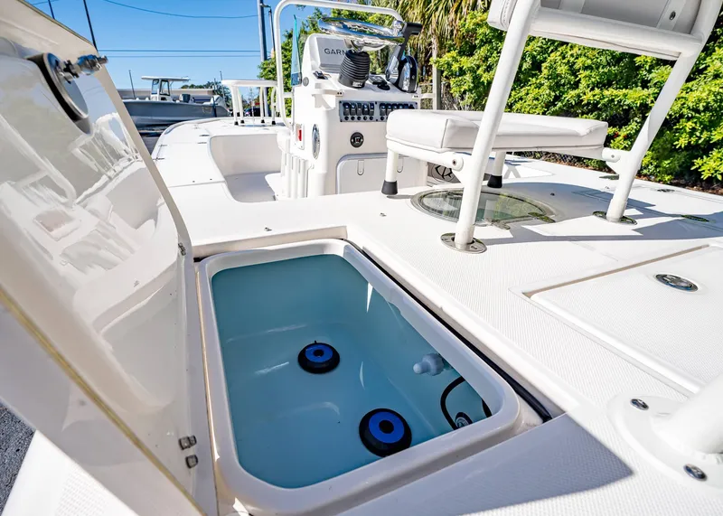 Slide: The Image of 2024 Spyder FX 19 Vapor boat interior with open storage compartment and seating. - 19